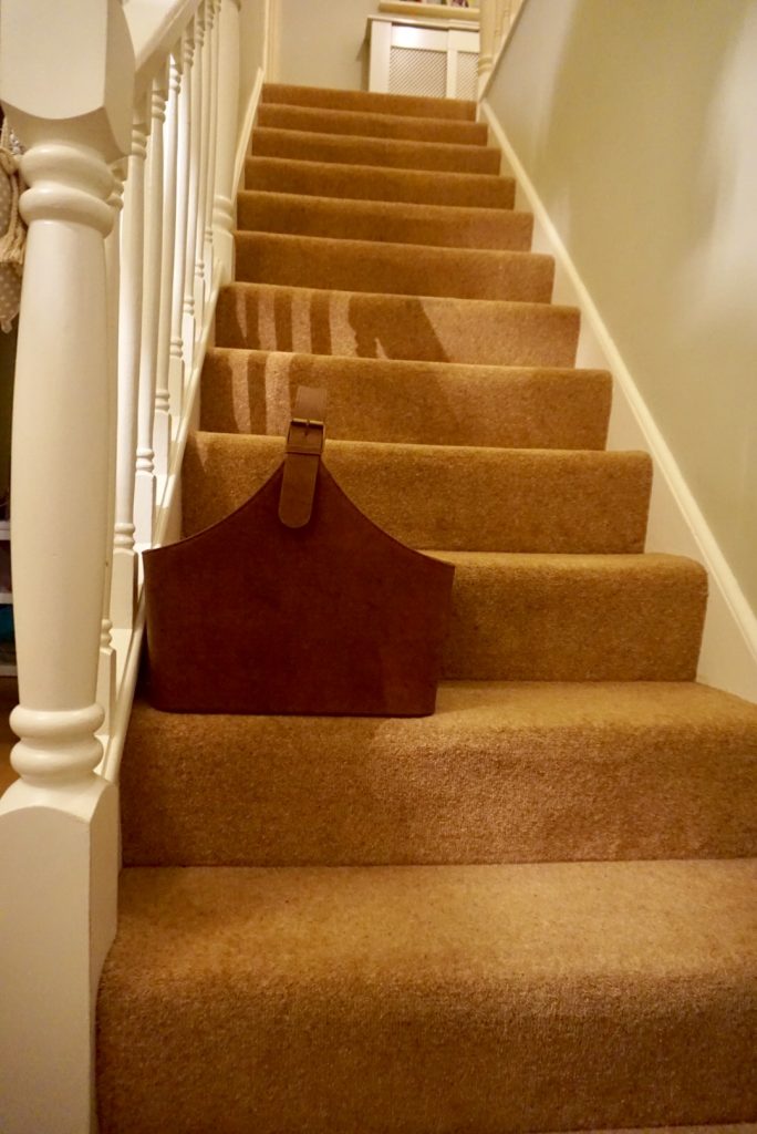 Leather basket to collect clutter in stairs